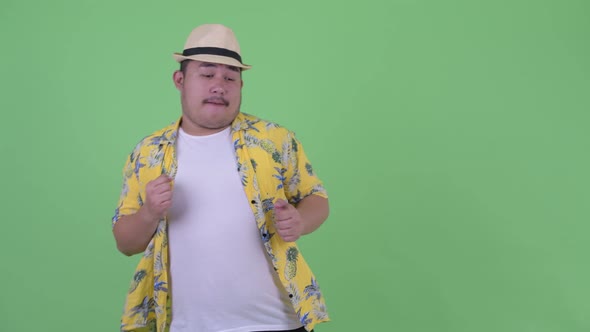 Happy Young Overweight Asian Tourist Man Dancing