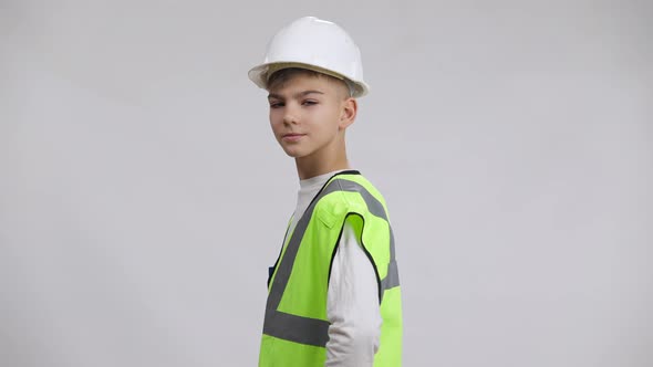 Side View Caucasian Boy Turning Crossing Hands Looking at Camera with Proud Facial Expression