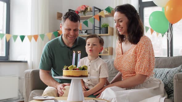 Happy Family with Birthday Cake at Home