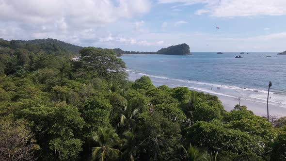 drone flight over the tropical forest towards a beach on the shores of the pacific ocean