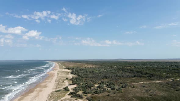 Drone Flight Over the Azure Sea with Waves and Sandy Coast