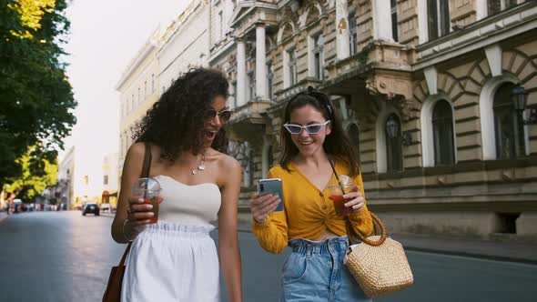 Young Females are Holding Bags and Cold Drinks