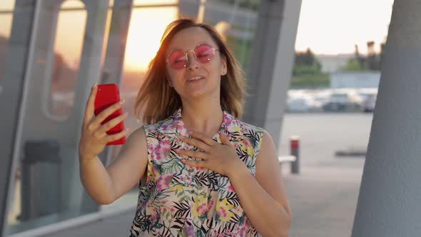 Tourist Girl Wearing Trendy Sunglasses Uses Phone. Using Smartphone for Call, Talk. Trip, Tourism
