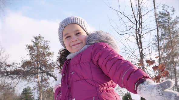 Happy, Fun Childhood on a Sunny Winter Day Outdoors. Daughter Plays with the Father in Snowballs