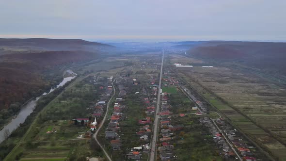 Panorama aerial view of mountain valley village with small rural area