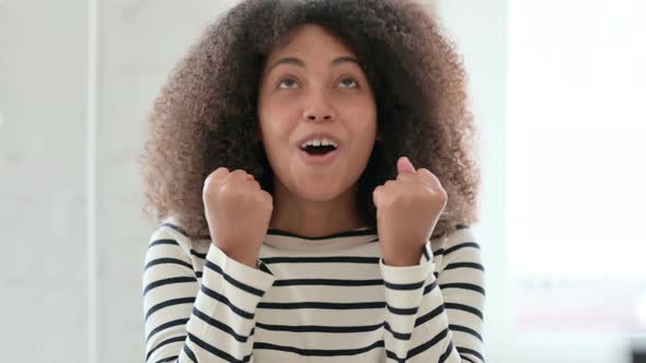 Excited African Woman Celebrating Success