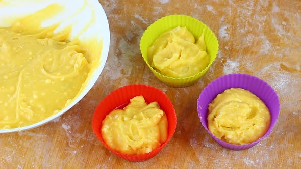 Woman Falls Asleep with a Spoon Yellow Dough in a Muffin Baking Dish at Home in the Kitchen