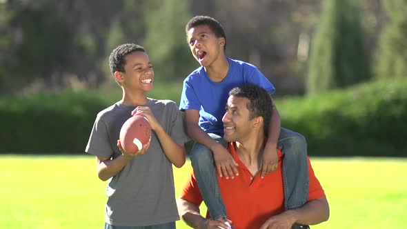 Group portrait of a father and his sons with a football