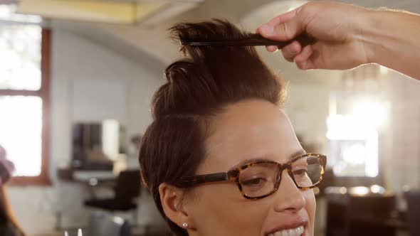 Male hairdresser styling customers hair