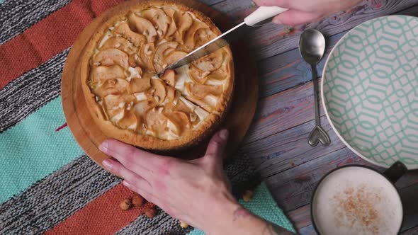 Cutting Apple Pie Top View. Cutting a Piece of Delicious Pie with Crusty Crisp with a Knife