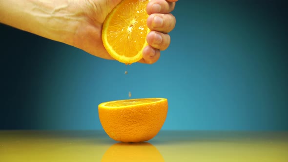 Hand Squeezing Out Fresh Orange