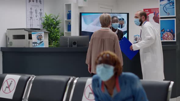 African American Receptionist with Face Mask Working on Appointments