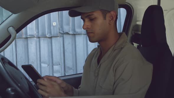 Young male van driver with a warehouse delivery