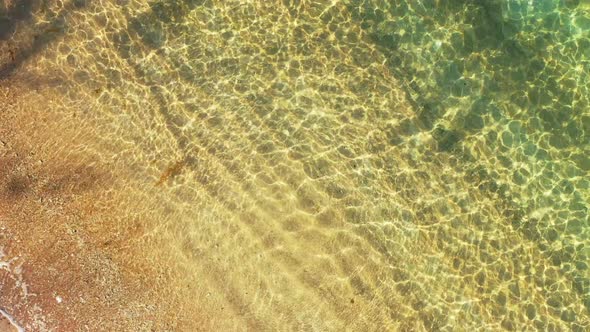 crystal clear sea water splashing on the golden sand beach, aerial high angle seascape , the tropica