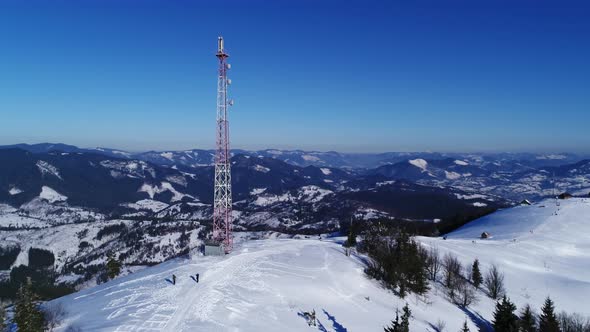 Flying Over Radio Communications Tower, Mountain Snow Covered Winter Landscape