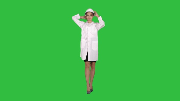 Woman Engineer in White Robe and White Hard Hat Walking