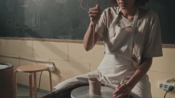 Woman Dripping Water on Clay Craft