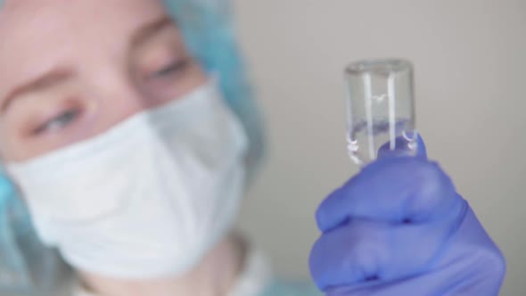 Doctor draws medicine into a syringe