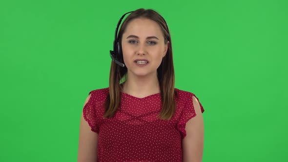 Portrait of Tender Girl in Red Dress Is Singing Into a Microphone and Moving To the Beat of Music