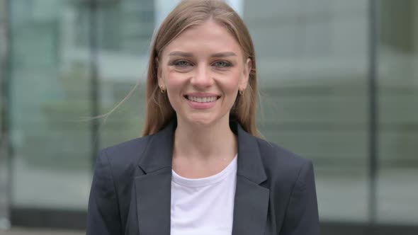 Portrait of Attractive Businesswoman Smiling at Camera Outdoor