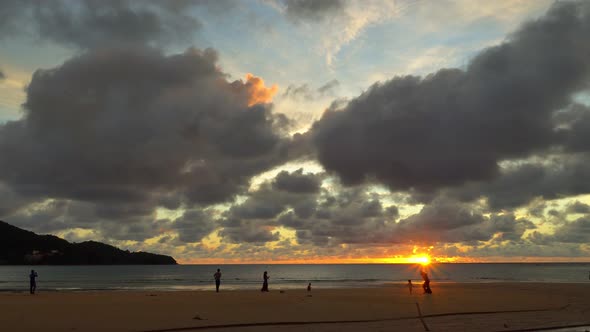 Tourists Relax On Naiyang Beach At Beautiful Sunset.