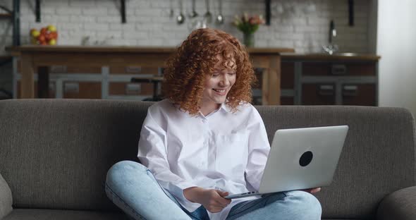 Happy Redhaired Woman with Curly Hair Talking Using Laptop Taking Via Online Virtual Chat Video Call