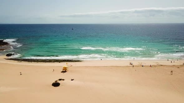 Beach and ocean during summer vacation day with tourists and people enjoying