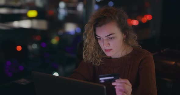 Woman Writes Number of Credit Card Into Laptop Online Banking