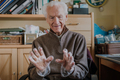 Elderly man puts on disposable protective gloves - PhotoDune Item for Sale