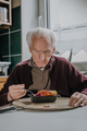 Single senior eats dinner at home - PhotoDune Item for Sale