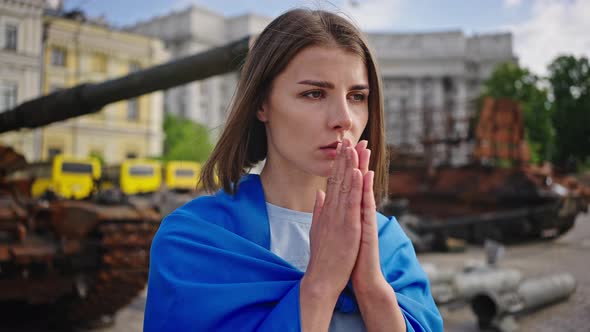 Woman Puts Hands in Prayer Gesture Begging for Peace