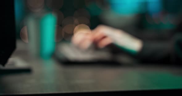 Close Up of a Young Female Hackers Hands Writing Malware on a Computer Keyboard in