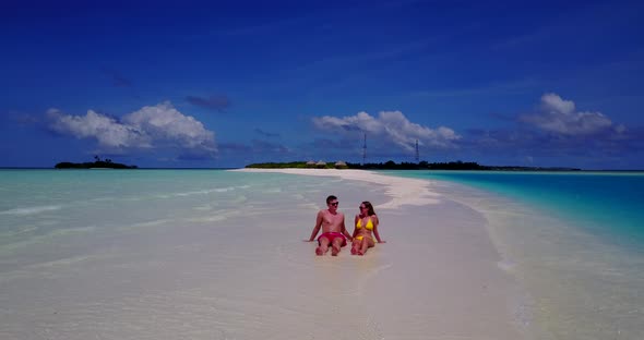 Romantic couple on honeymoon vacation live the dream on beach on white sand background 4K
