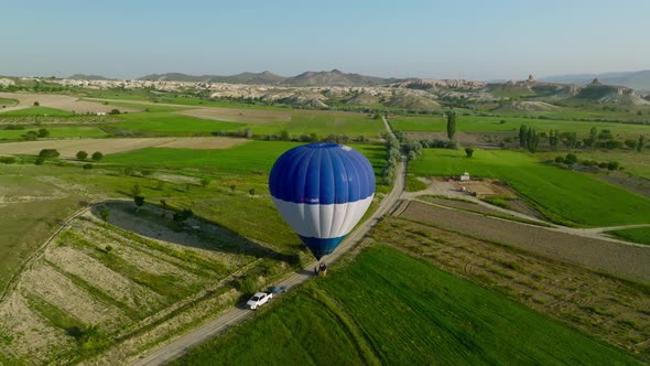 4K Aerial view of Goreme. Colorful hot air balloons fly over the valleys.