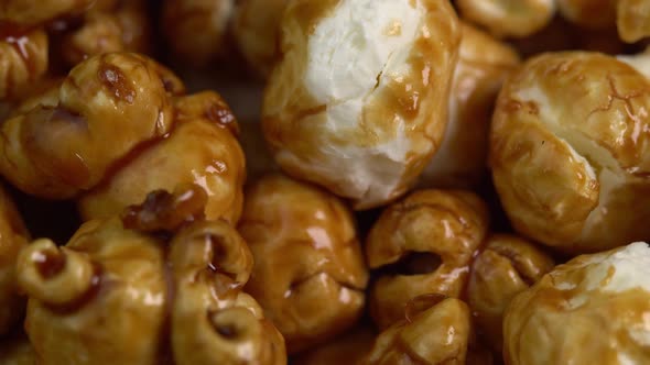 Coffee taste popcorns rotating in macro. Caramel popcorn. Healthy food for morning breakfast