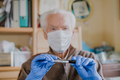 Old man wearing mask, holding Covid-19 sample - PhotoDune Item for Sale
