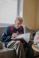 Elderly man reading book at home - PhotoDune Item for Sale