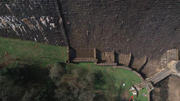 Top down aerial view rising above Scar house reservoir infrastructure high angle view overlooking da