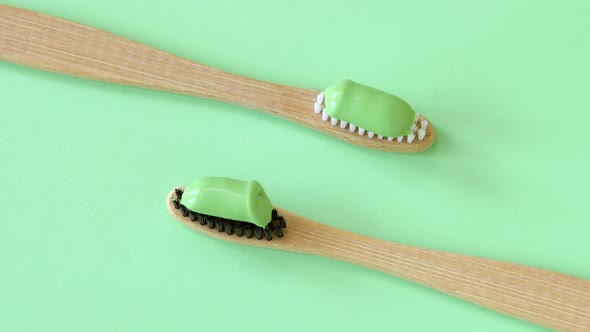 Bamboo toothbrushes with natural toothpaste rotating top view