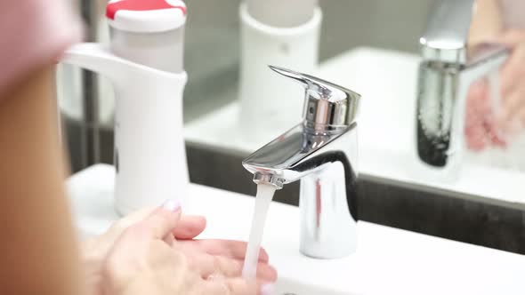 Woman Washing Her Hands with Liquid Soap Under Tap Closeup  Movie Slow Motion