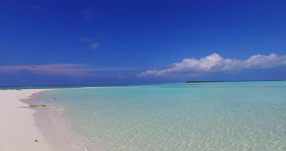 Wide angle overhead abstract view of a white sand paradise beach and blue water background in vibran