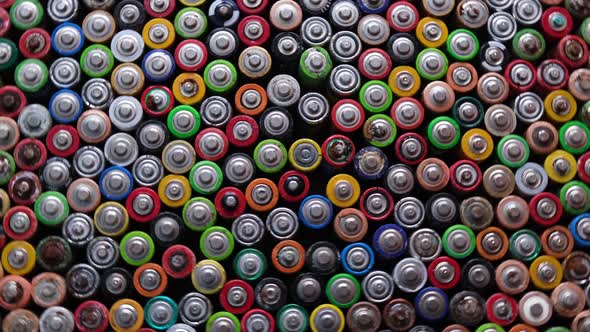 Used Batteries are Stacked in the Center Types AAA AA 9Volt Top View Background