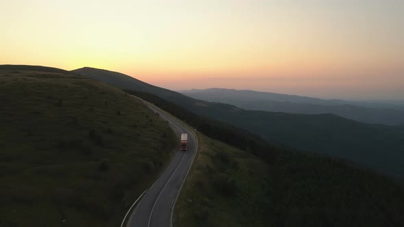 Aerial View of a Cargo Truck Driving of Into the Sunset