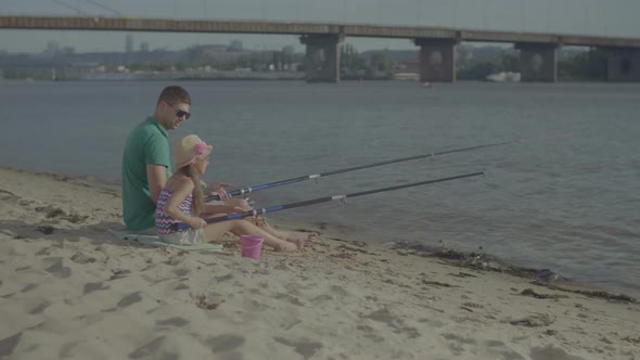 Happy Father and Daughter Fishing Together