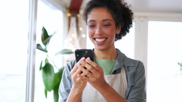 Laughing African woman talking by video call on phone