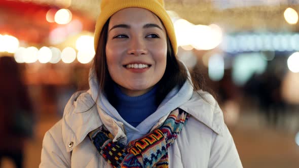 Asian woman walking at the evening street