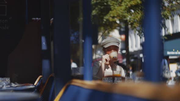 Young attractive woman in a cafe outdoors