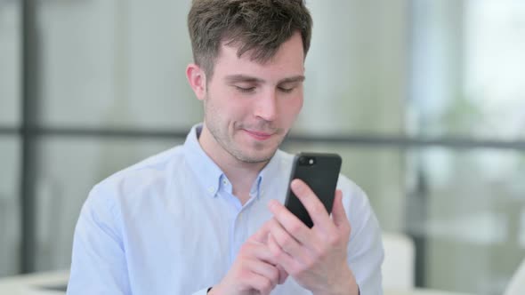 Portrait of Young Man Using Smartphone