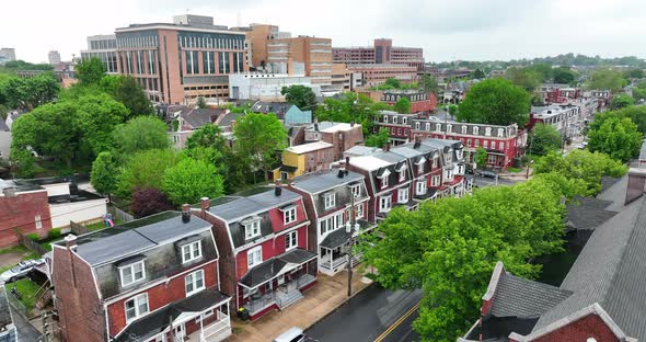 Wet houses in city with hospital in background. Low income city living. Aerial view from drone on ra