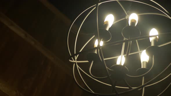 Round Iron Chandelier Hangs in a Room